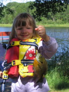 Alyx is proud of the nice gill she caught from the dock.