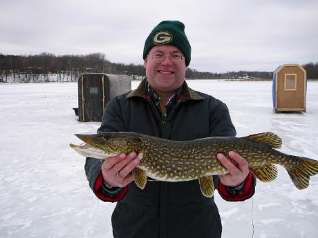 Bryan A. with a 27-inch pike from a nearby lake, February 2008.