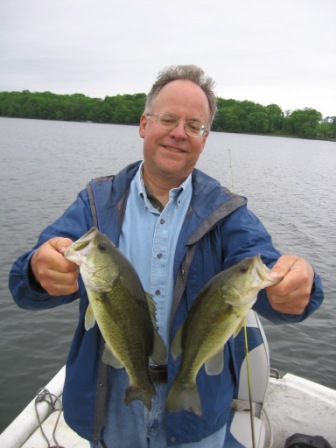Bryan A. with a pair of bass caught on Benoit Lake, May 2012.