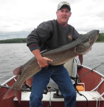 Dave Broertjes caught and released this 52 inch musky; his wife Carolyn netted the fish.