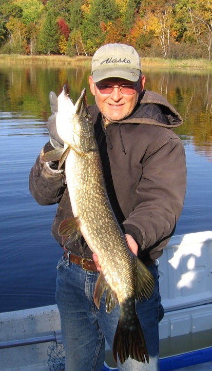 That's me with a 34-inch pike I caught and released on Benoit Lake.  The fish took a Thumper Tail, which was made by my friend Jim Stroede of Trego.  September 30, 2012.