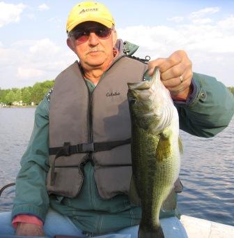 George N., my cousin, with a nice 18-inch largemouth he caught and released on Benoit Lake, June 2008.