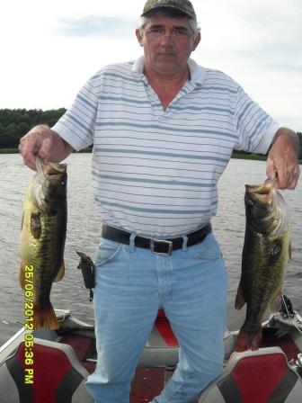 Jim A. with a pair of nice bass that he and his brother Dave caught on Rice Lake, June 2012.
