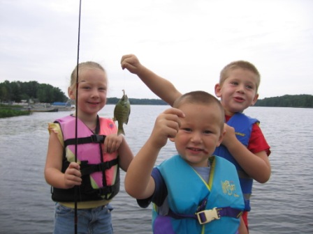 Kailey, Landon, and Corbin enjoy the fishing from the dock at Rainbow Bay Resort on Benoit Lake, July 2012.