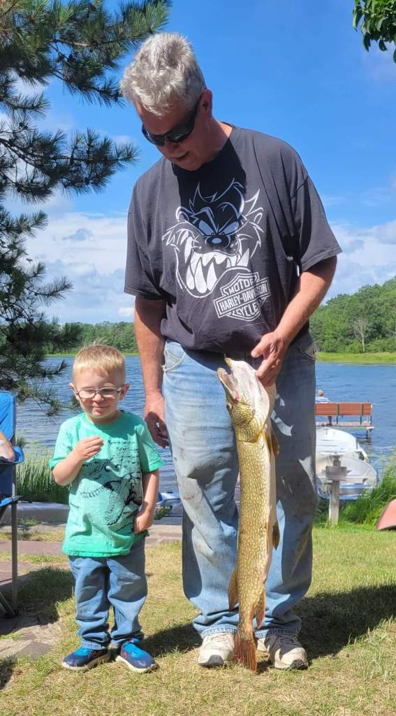 Mark C. with nephew Haiden W.  Mark caught this nice 35.5-inch pike on Benoit Lake, July 2022.