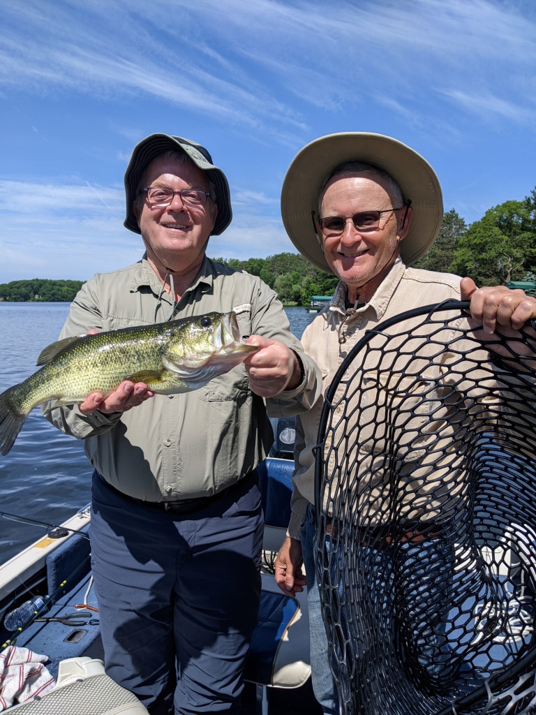 Bob N and Dave C with a bass, near Spooner, Wisconsin, June 2023