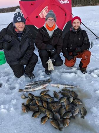 Erik N., Jacob C., and Jake K. with some fish that they caught on a Burnett County, Wisconsin lake, February, 2024.