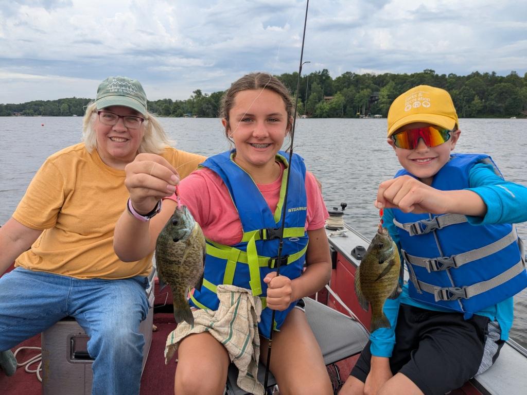Jackie, Layla, and Jack caught some nice bluegills at the deep weedline on Benoit Lake, July 2025.