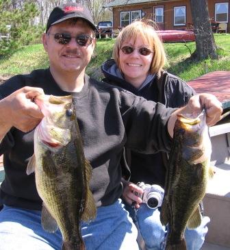 Martin and Deanna V. with 19 and 16 inch bass that they caught and released on Benoit Lake, May 2008.